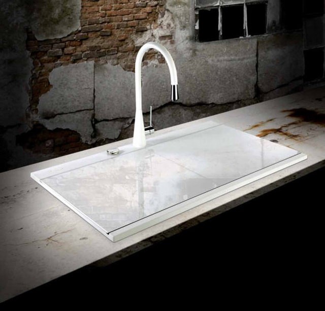 A modern kitchen sink with a built-in sliding lid. 