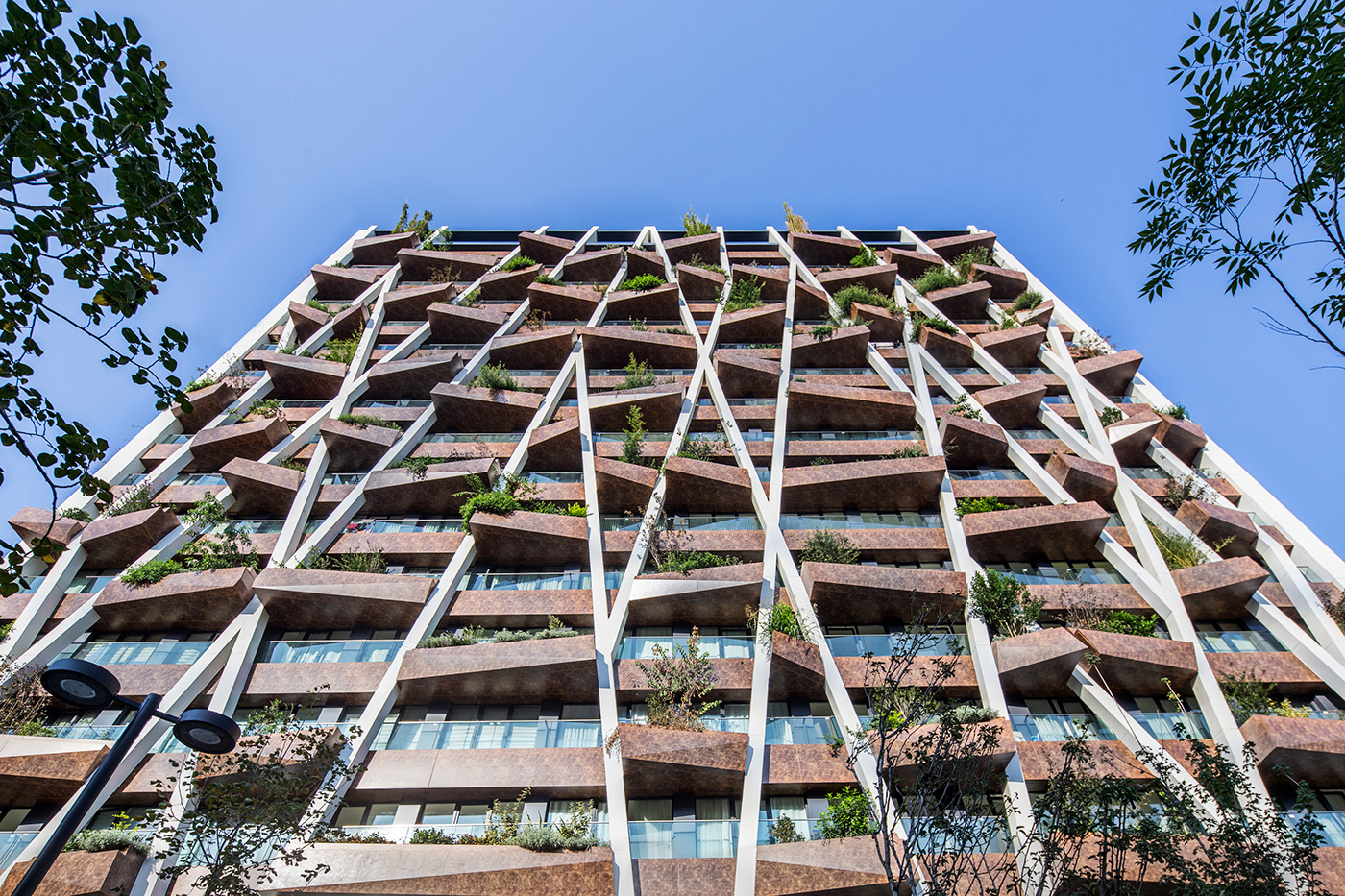 Shot of the GREENOX Residence's exterior vertical forest, as seen from the street below.