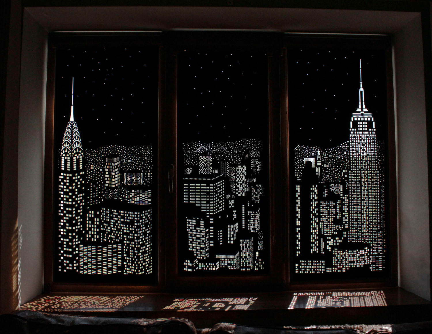 Closing set of blackout blinds, with the New York City skyline etched into them for decorative effect.