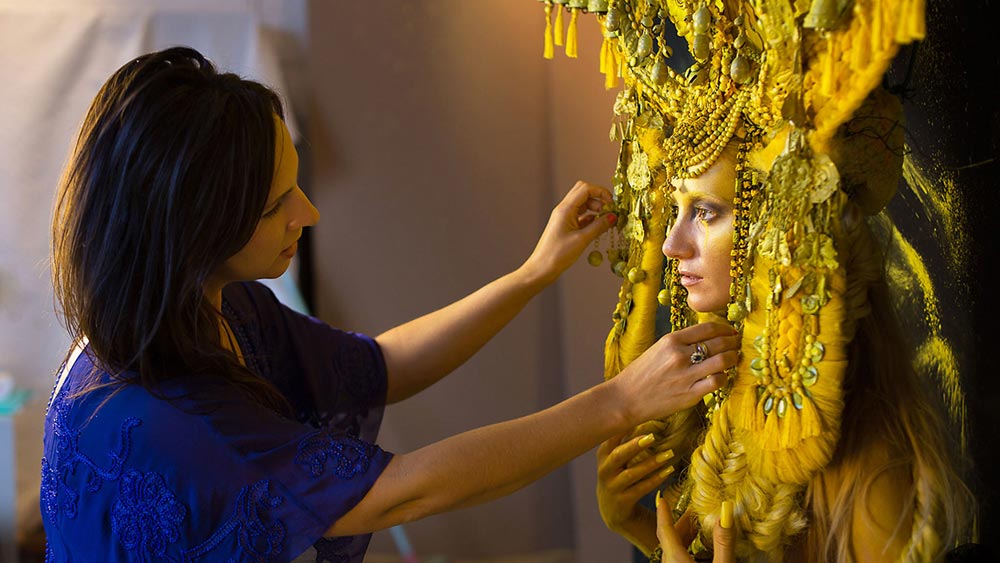 Artist Kirsty Mitchell preps a model during a shoot for her "Wonderland" photography series.