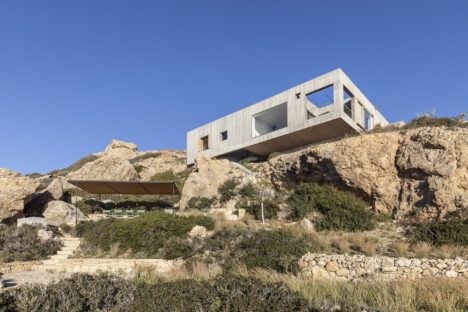 Exterior shot of the cliffside "Patio House" in Greece.