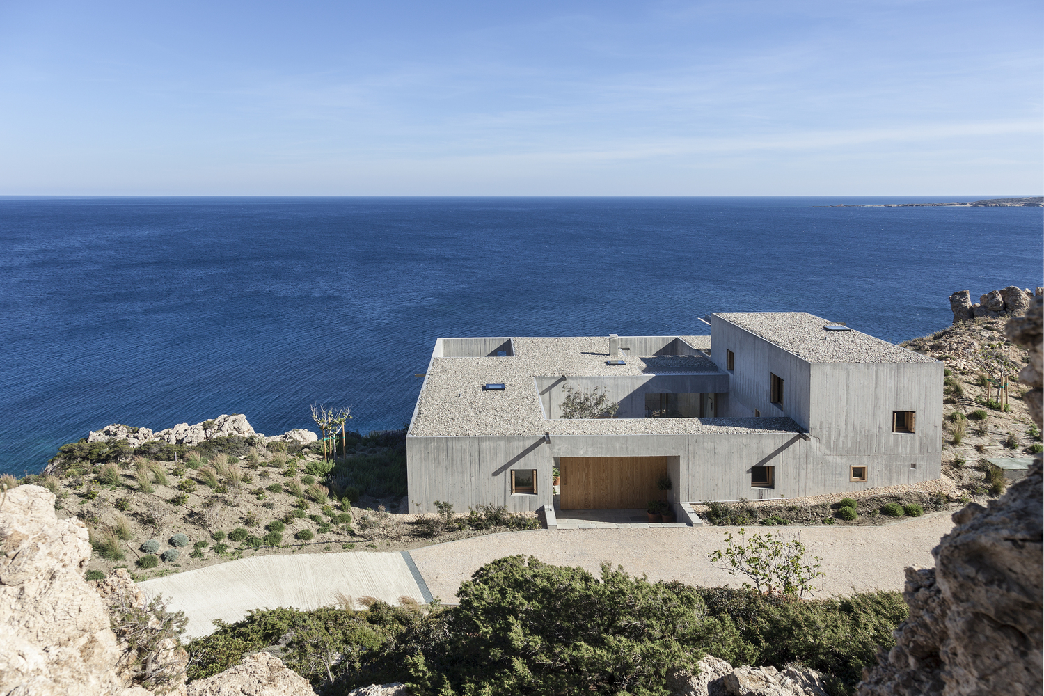 Exterior shot of the cliffside "Patio House" in Greece. 