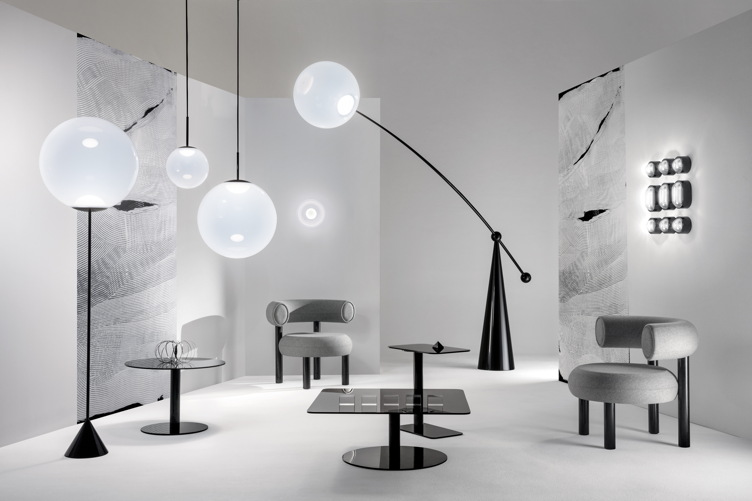 Minimalist plush chairs from Tom Dixon's FAT furniture collection placed alongside fixtures from his new OPAL lighting series.
