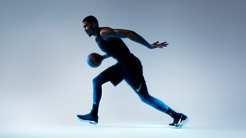 Athlete playing basketball while wearing the Adapt BB self-lacing sneakers. 