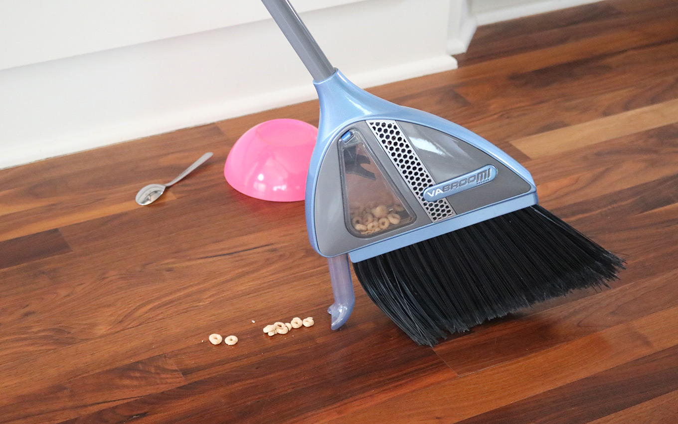 The VaBroom multipurpose broom picks food scraps up off the floor. 