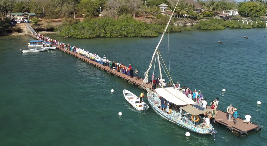 The FlipFlopi dhow docked alongside a small pier in Africa.