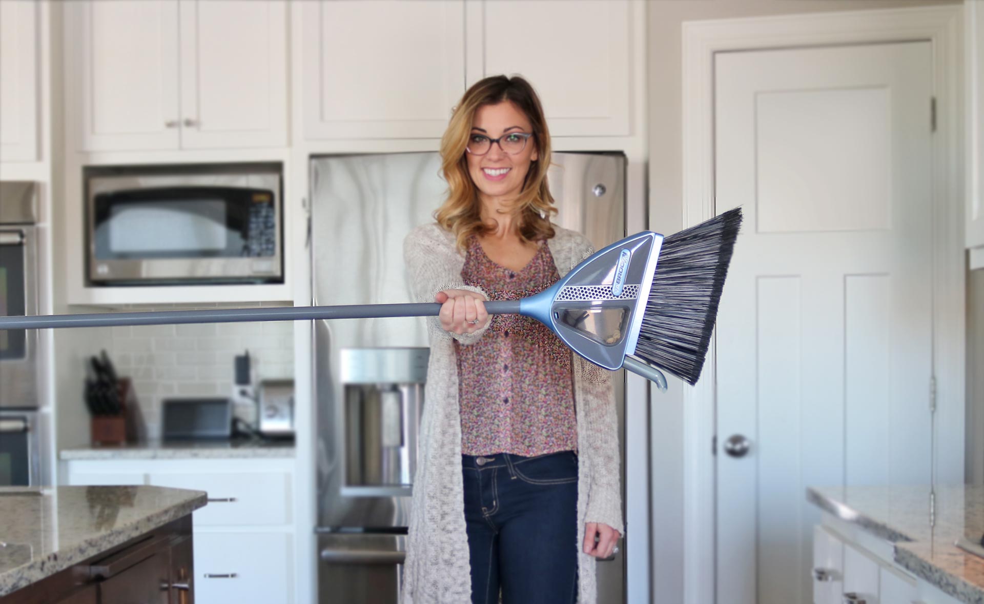 Woman uses VaBroom to clean up a household mess.