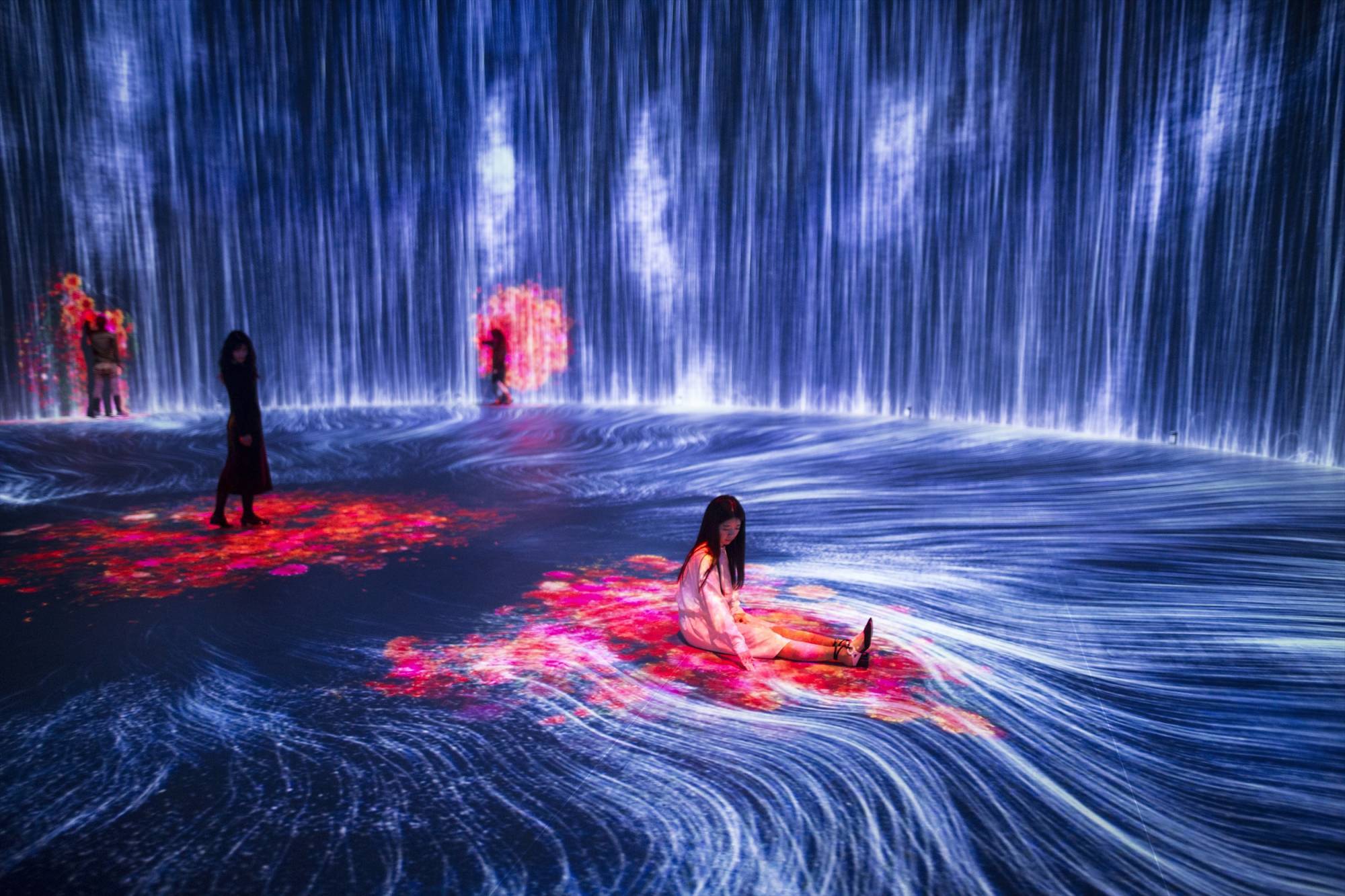 Stills from "Universe of Water Particles in the Tank," a new art installation from teamLab set inside reclaimed oil tanks.