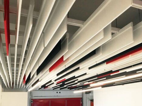 TURF Design's straight baffle ceiling system hanging over an office space.