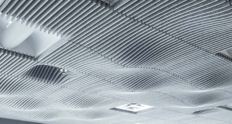 TURF Design's Swell ceiling system hanging over an office space.