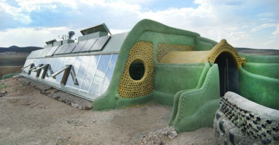 An earthship house located in a desert environment.