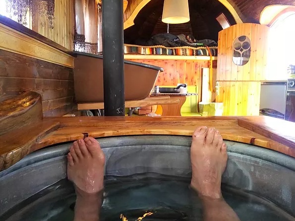 Man soaks up some suds in the Griswald's steel bathtub