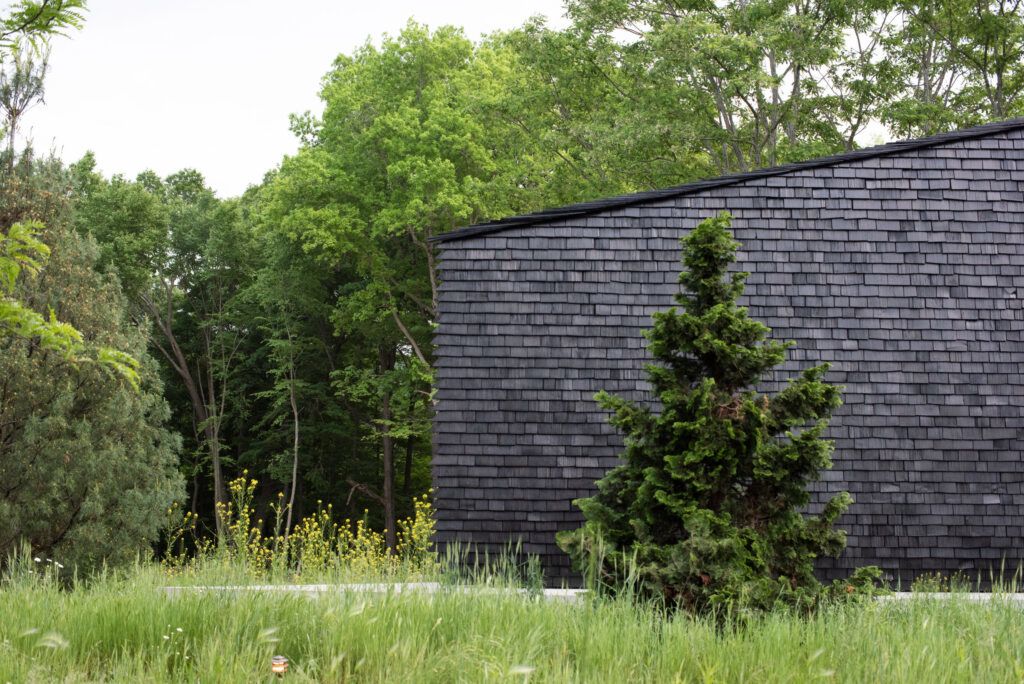 "Hudson Valley House II," a complex of stark black cottages in Upstate New York.