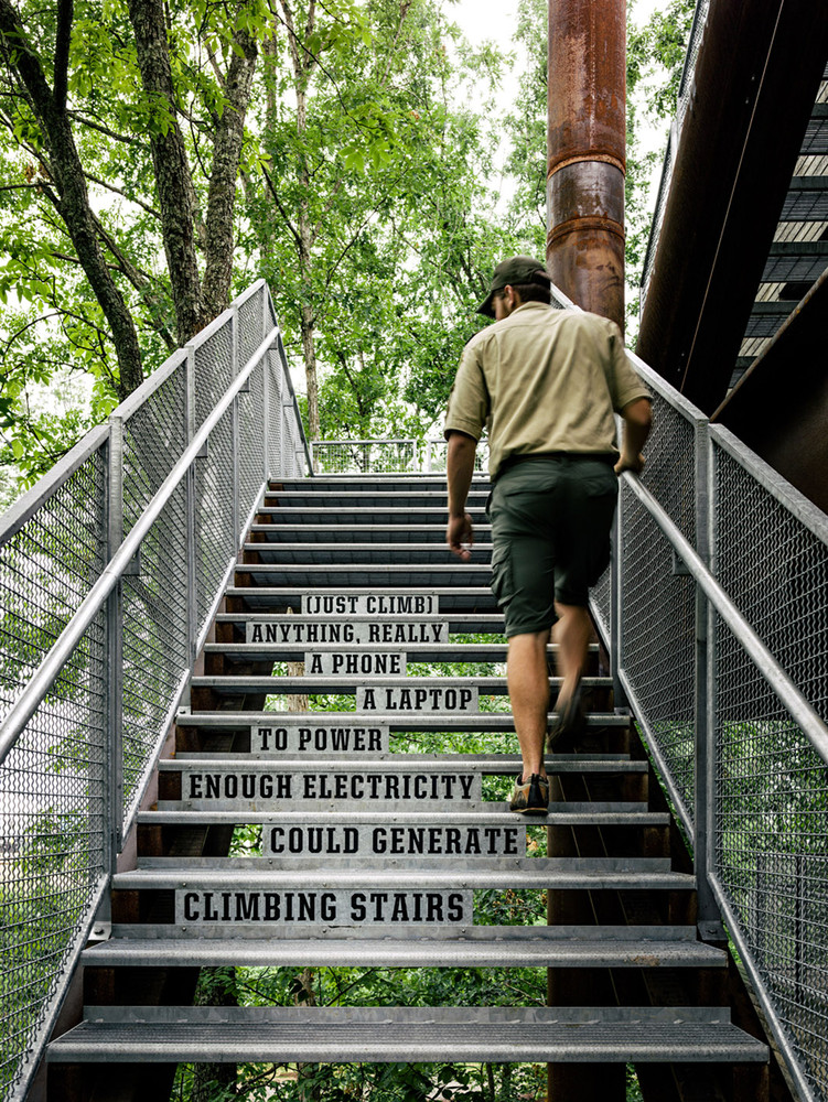 A scout climbs the stairs of the Sustainability Treehouse.