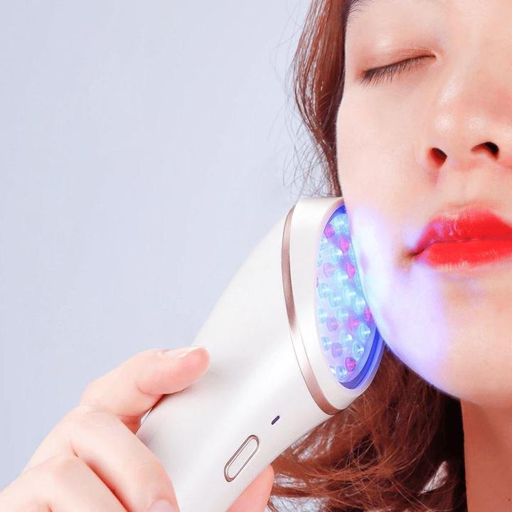 Young woman uses LightStim for Acne LED Light Therapy on her face.