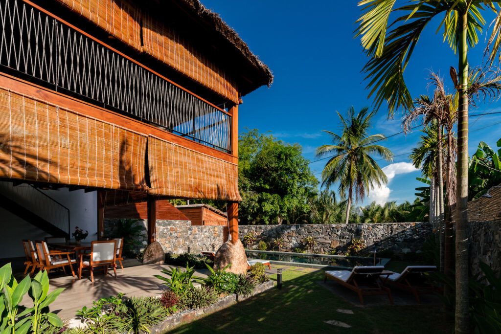 Bamboo shades run along the outer edges of D1 Architects' M Villa Duplex in Hoi An, Vietnam.