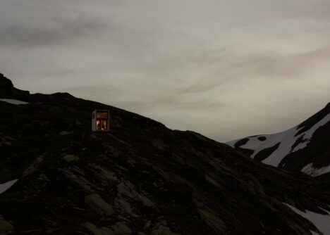 The mirrored On Mountain Hut, barely visible in the twilight.