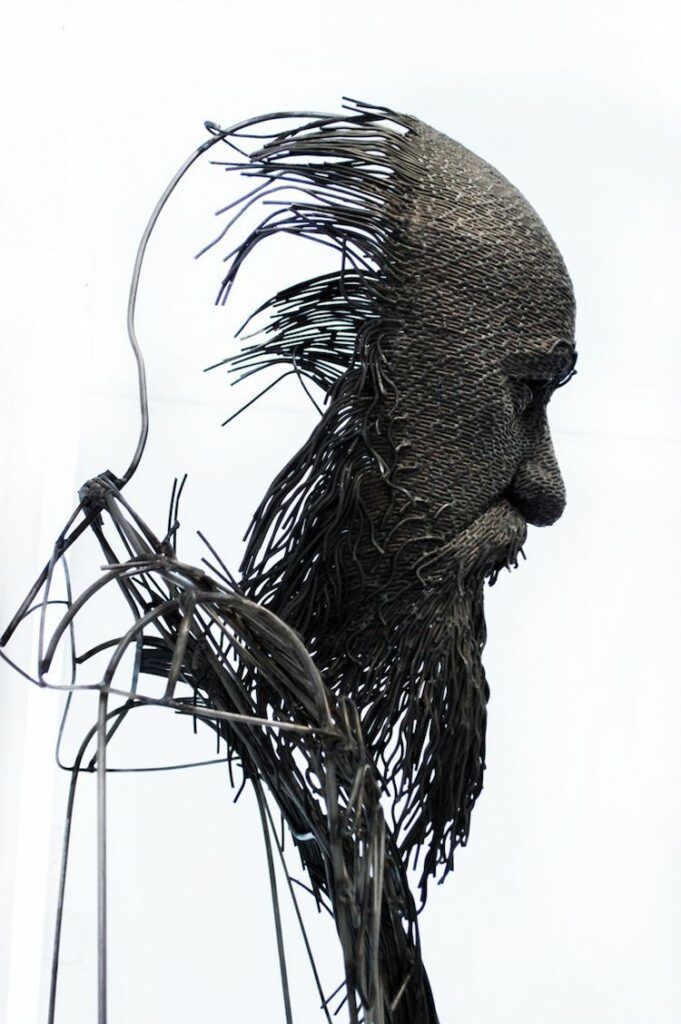 Metal wire sculptures of historic figures by artist Darius Hulea.