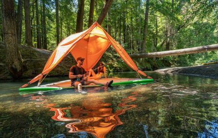 A family uses the Universe 5-Person Tree Tent as a floating diving board.