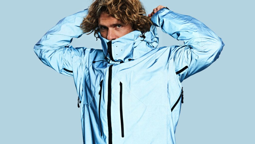Young man models Vollebak's Blue Morpho Jacket.