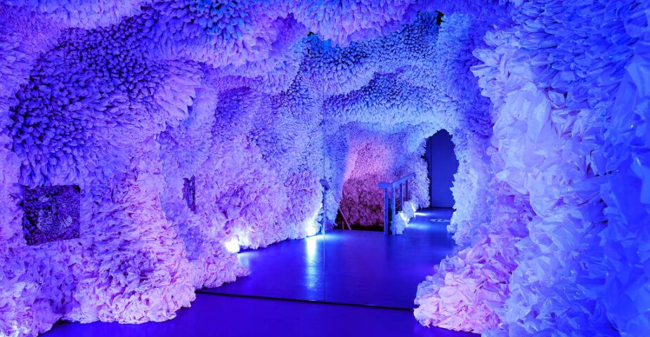 ocean cave art installation with purple and blue hues