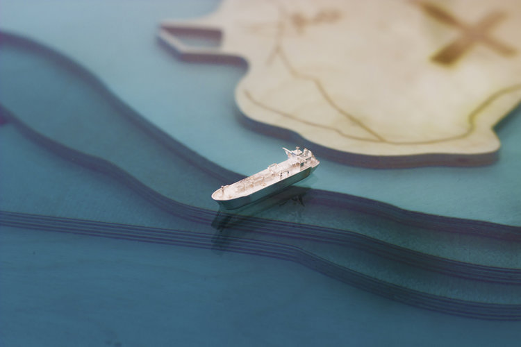 A tiny sterling silver ship featured on the Robben Island Coffee Table