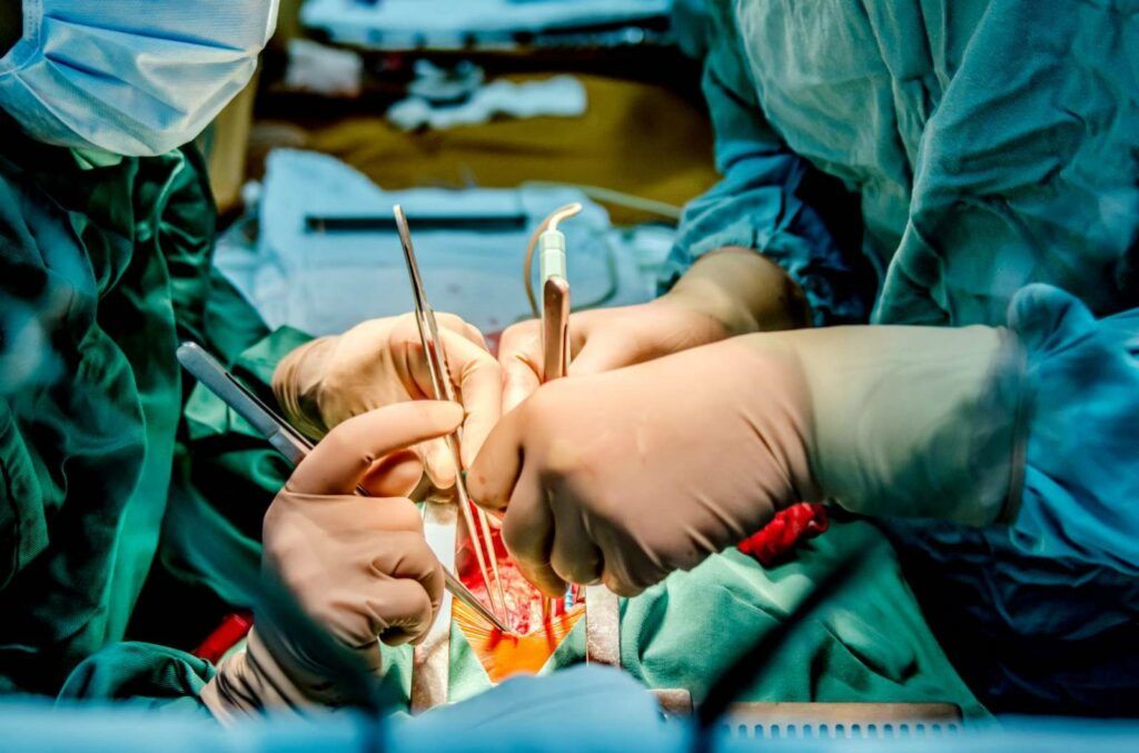 Doctors perform surgery on a patient.