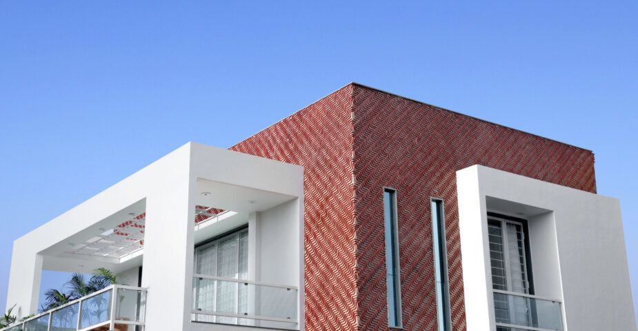 Exterior shot of a new home by Manoj Patel Design Studio, which uses clay tiles to promote passive heating and cooling