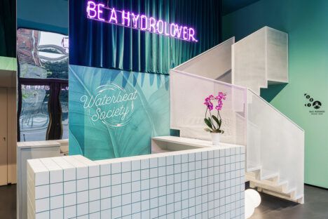 Waterbeat Society's trendy reception area, complete with neon signs and lots of sleek white tile